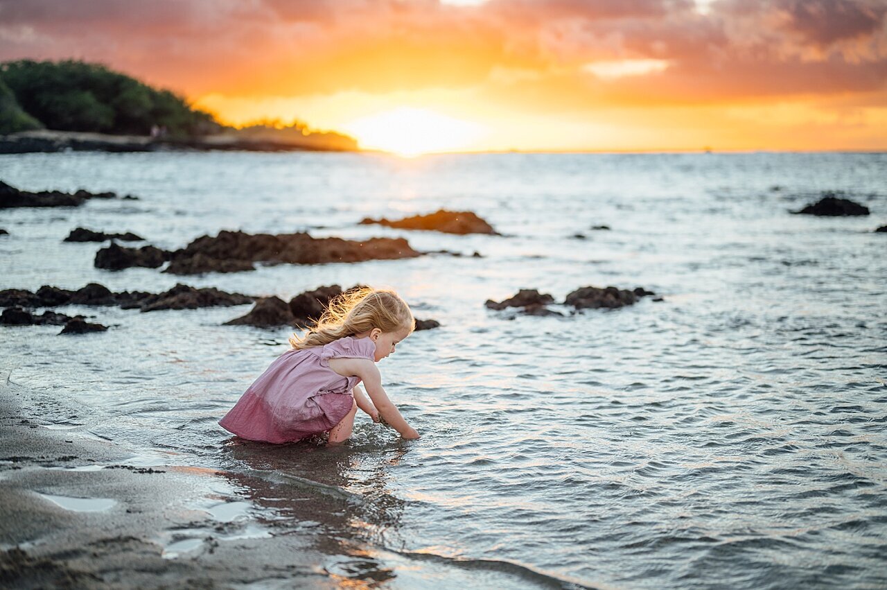 little girl playing in the water in hawaii