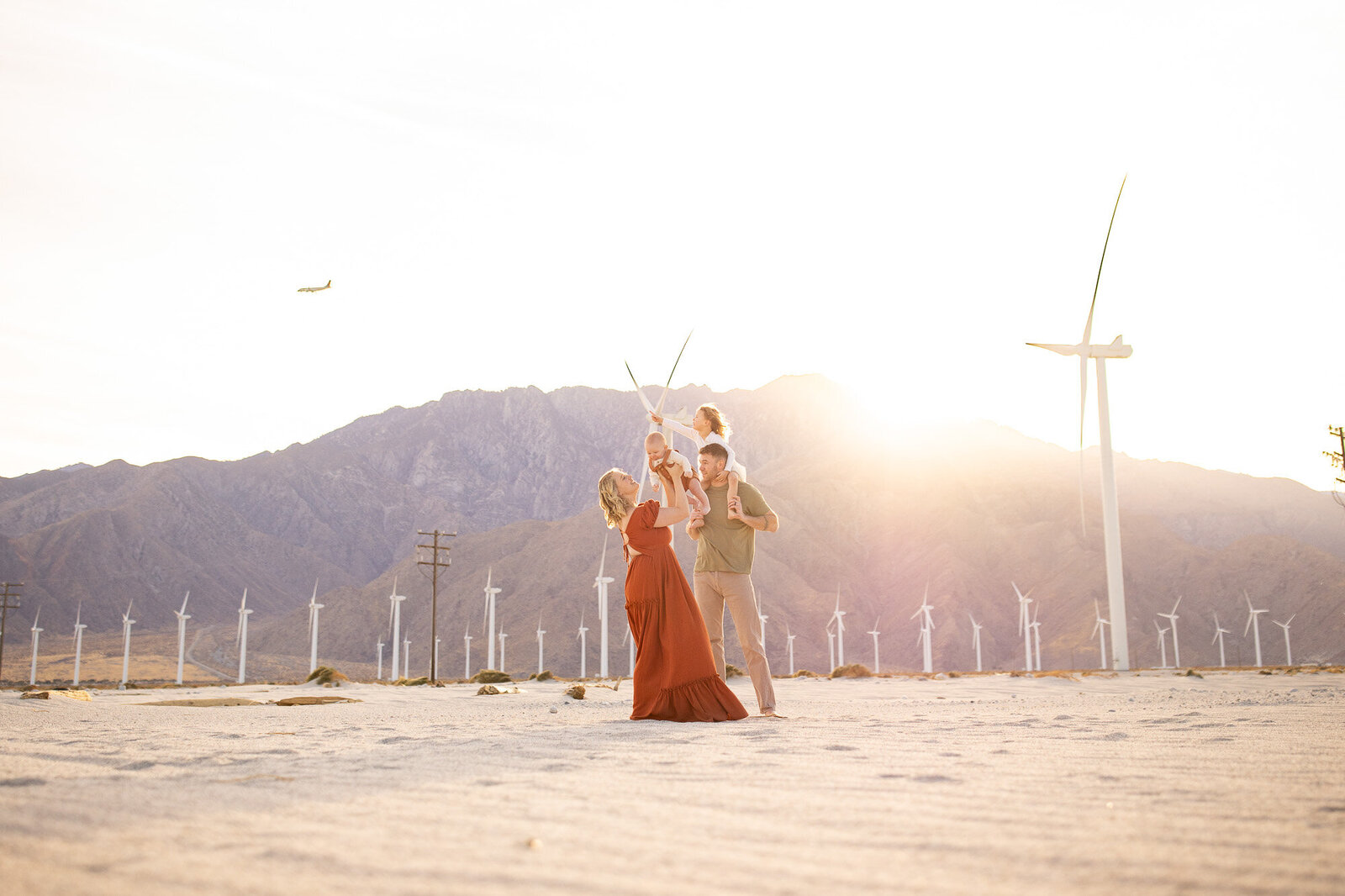 Family of four at the windmills in Palm Springs with a Palm Springs Family Photographer