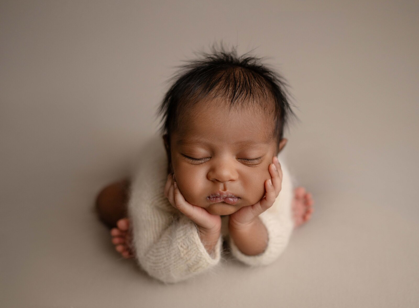 Newborn photography pose of baby boy in froggy pose. Newborn Photography session photographed at Jenni Nikki's photo studio in Woodstock, GA, near Marietta, GA.