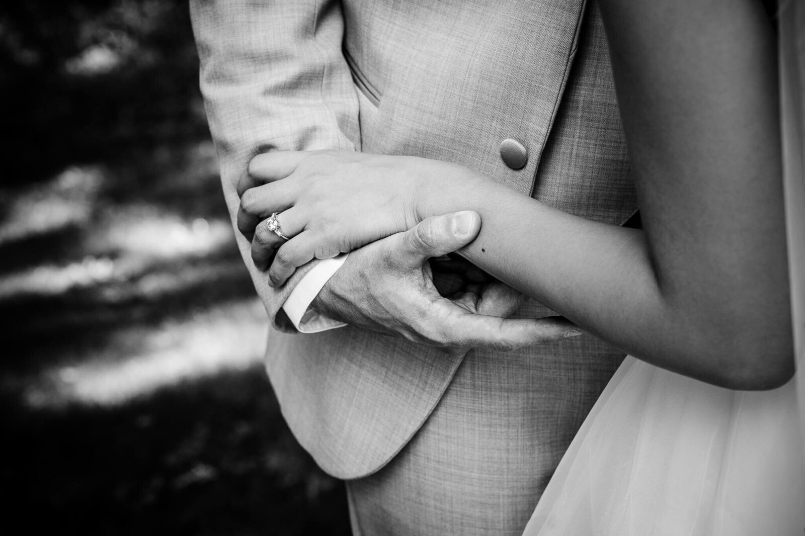 Closeup of bride and groom's hands.