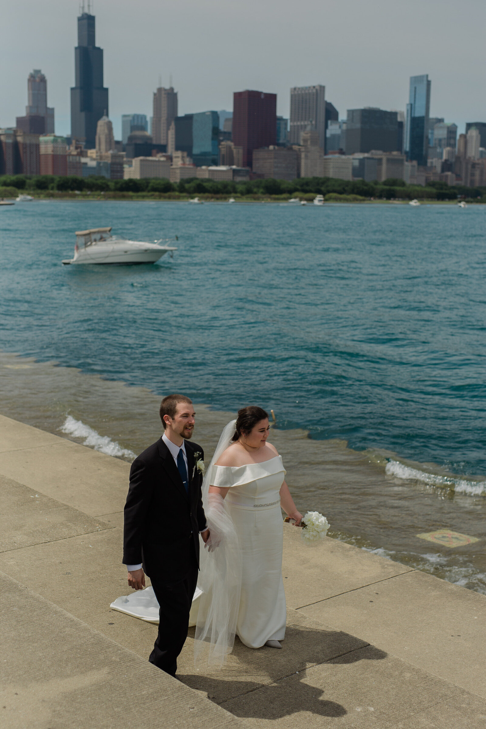 Couple walk by the sideline of the view of Chicago