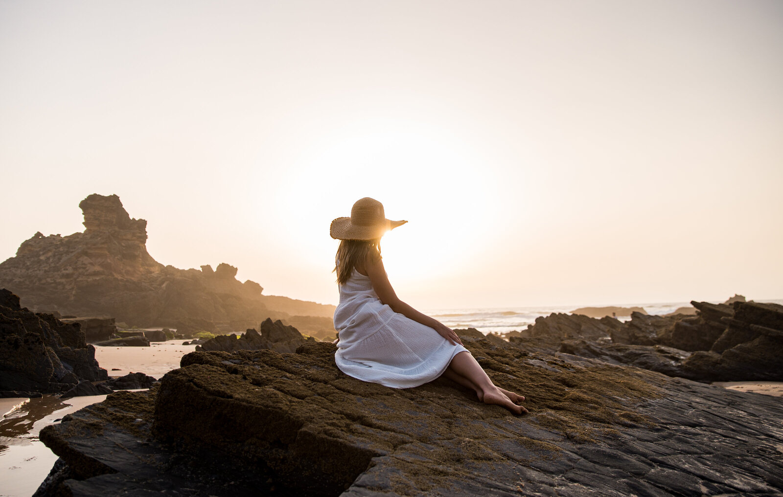 unrecognizable-woman-on-rocky-seashore-2022-07-28-20-38-59-utc