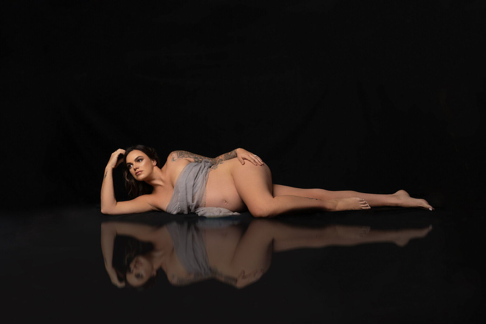 Maternity photographer with reflection on the floor