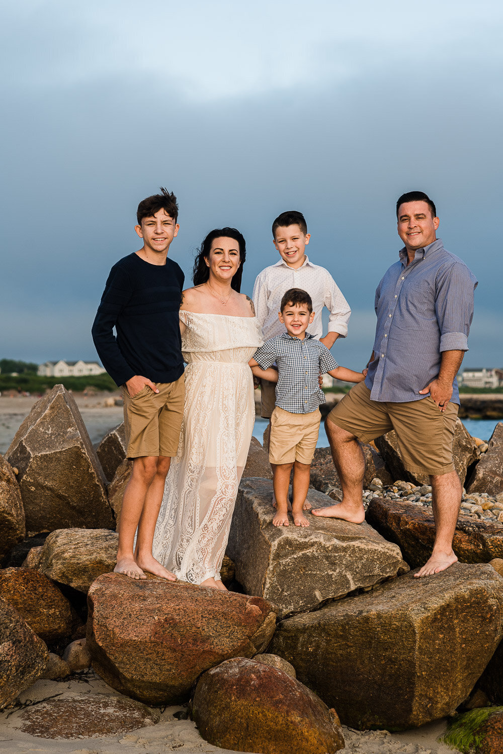 family on rocks at beach