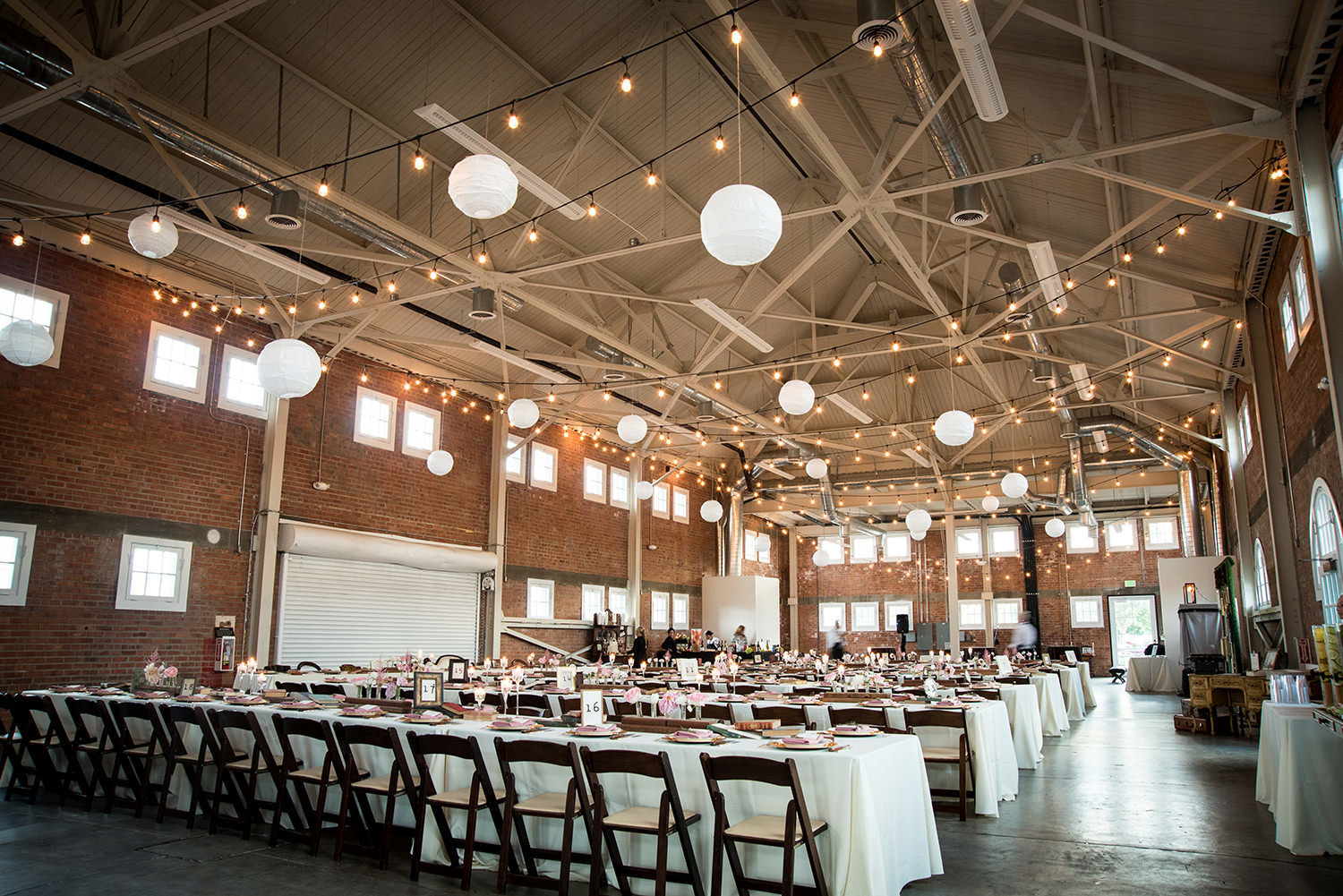 reception photo of brick with stunning details and farm tables