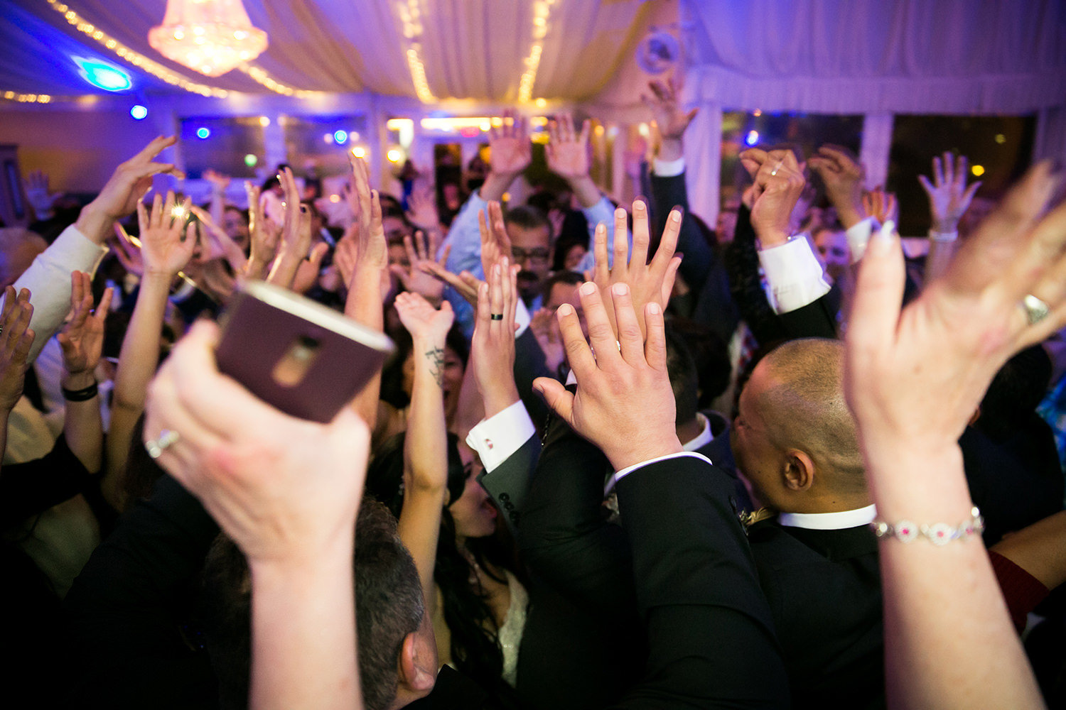 hands in the air dancing at reception