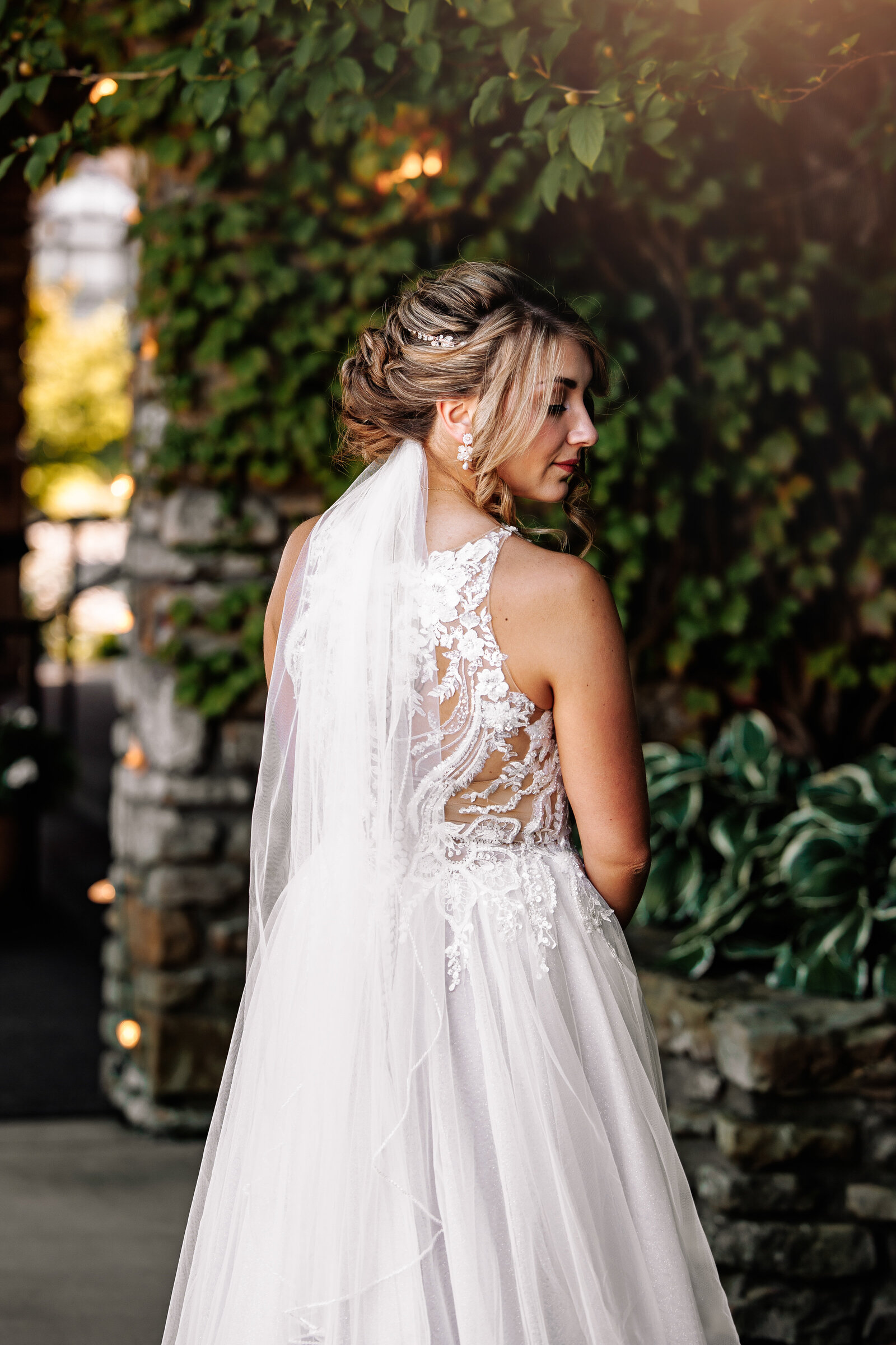 Bride looking over shoulder, shows off her beautiful gown