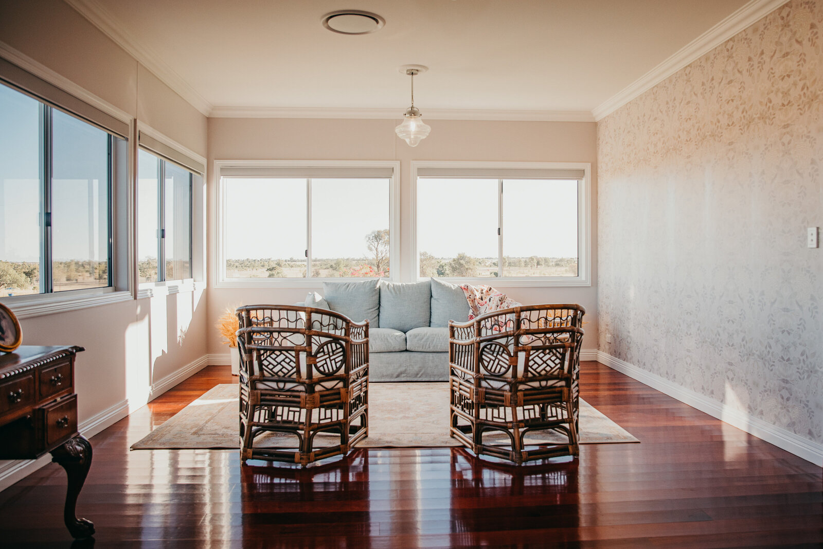 Stylish dining area with custom glass windows and energy-efficient aluminium frames, perfect for home renovation.