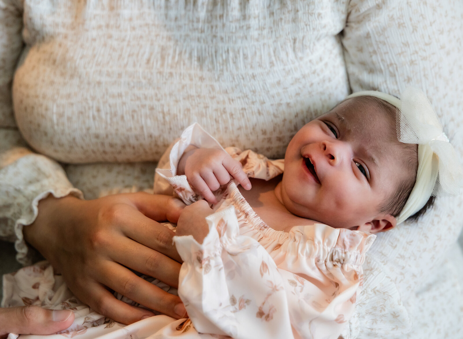 closeup of newborn girl smiling