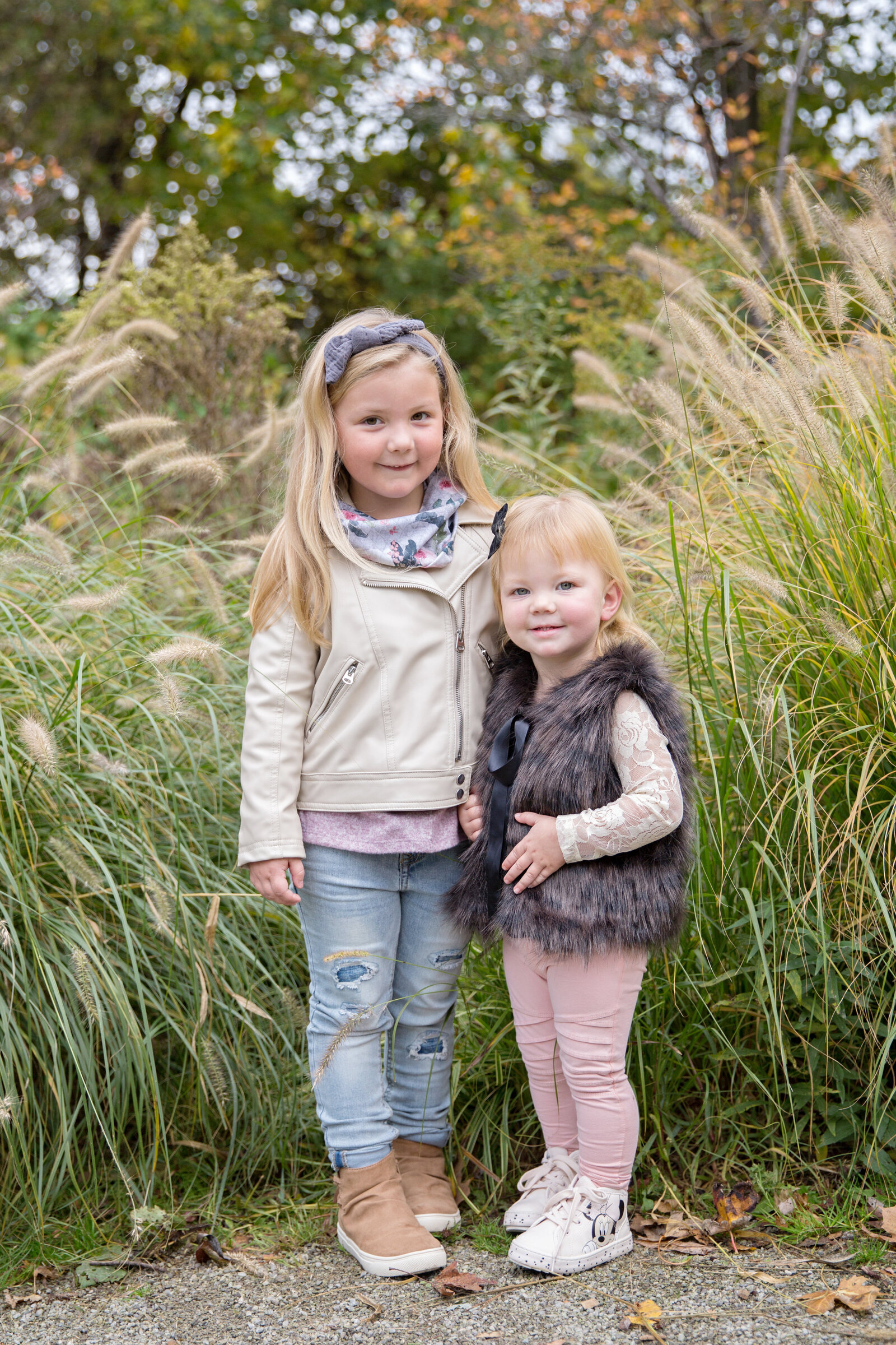sisters standing in tall grasses