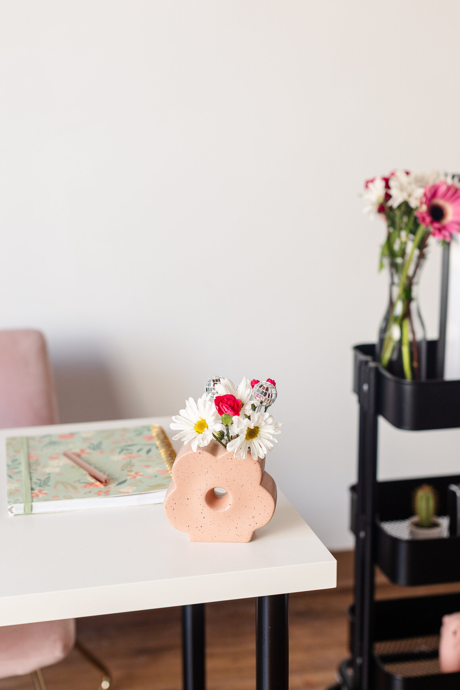 a shot of a desk with fresh florals 