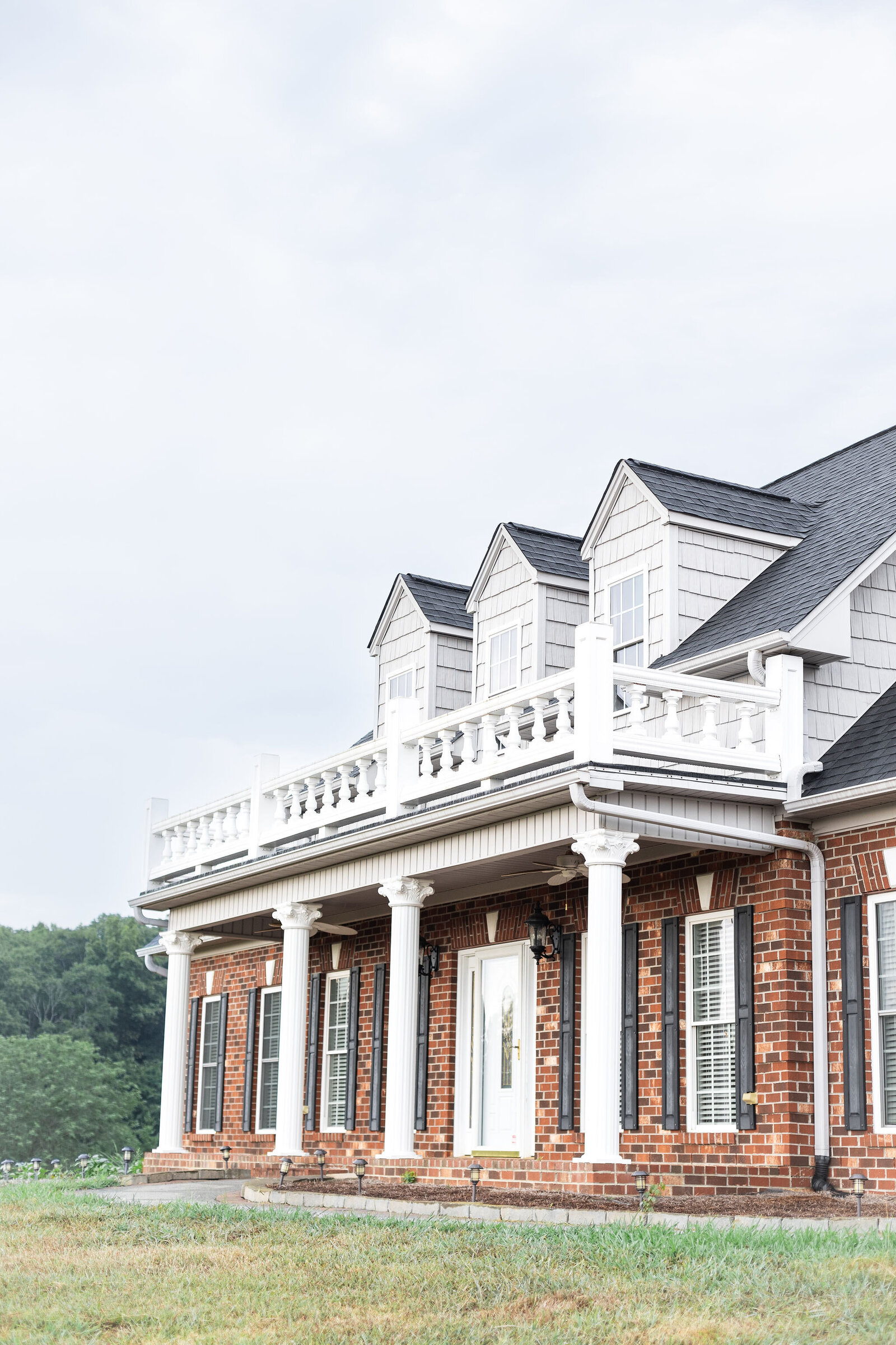 Grand brick estate surrounded by countryside at Willow and Stone Events in Mocksville, NC, offering timeless elegance for weddings and events.