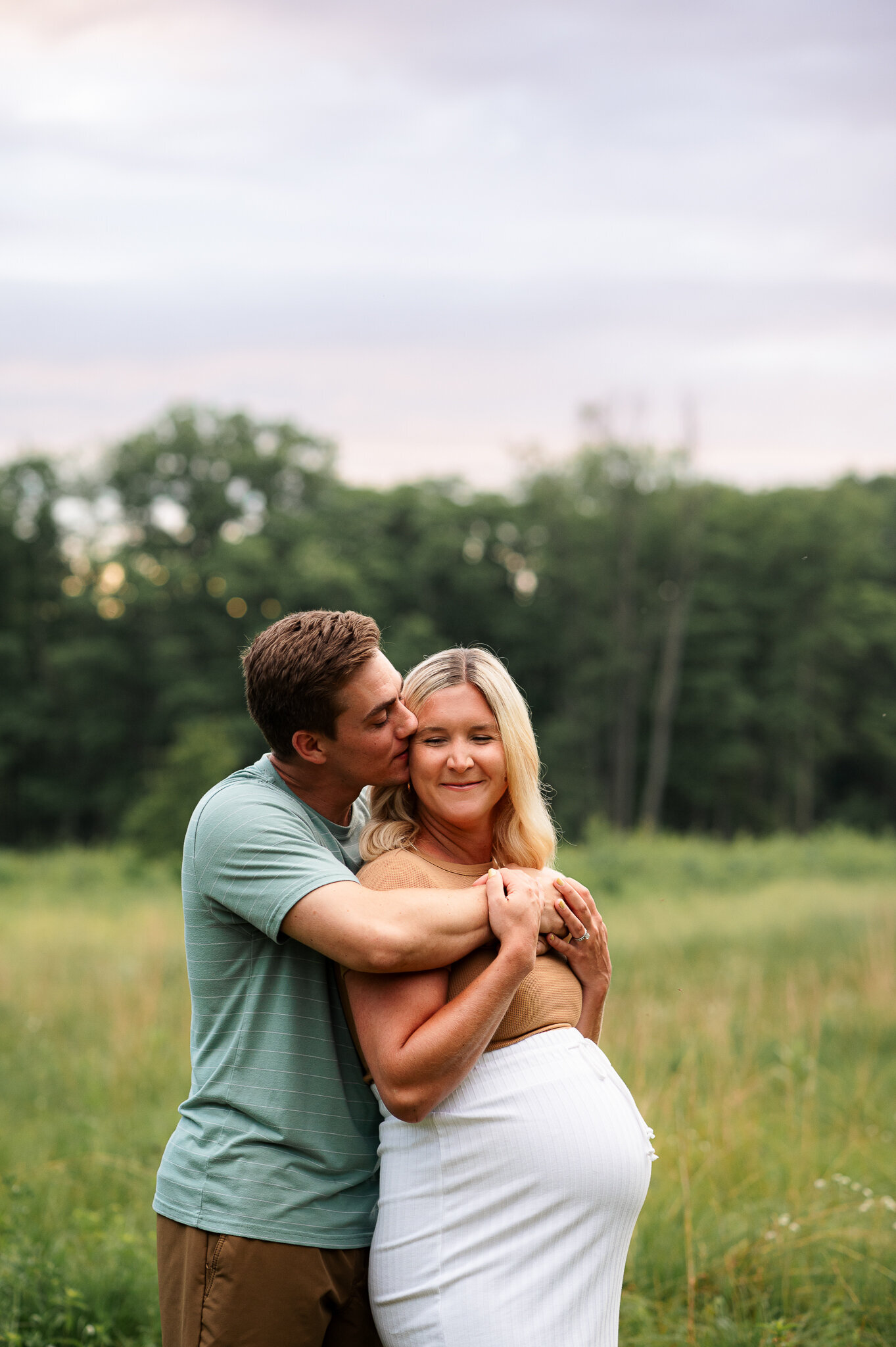 Husband kissing pregnant wife maternity session