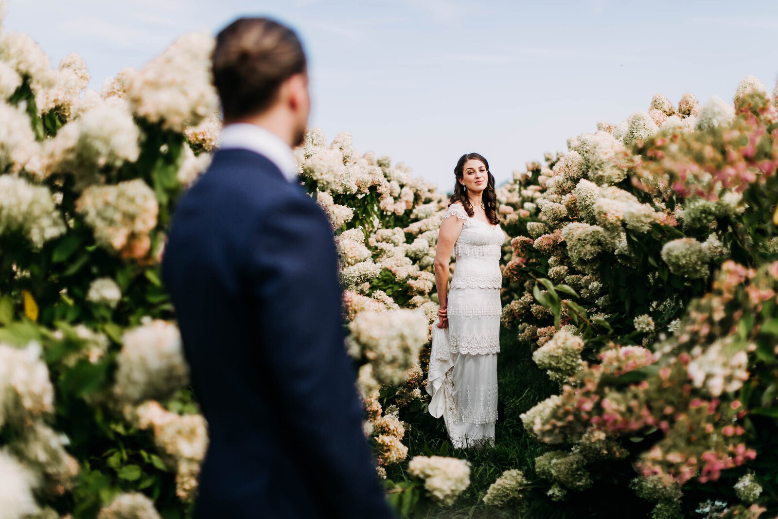 bride and groom in flower field
