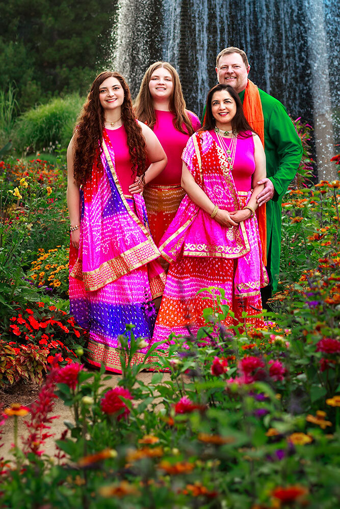 inidan-family-photos-denver-botanic-garden-waterfall-blue-flowers-warm-colors-red-yellow-orange-purple-cultural-heritage