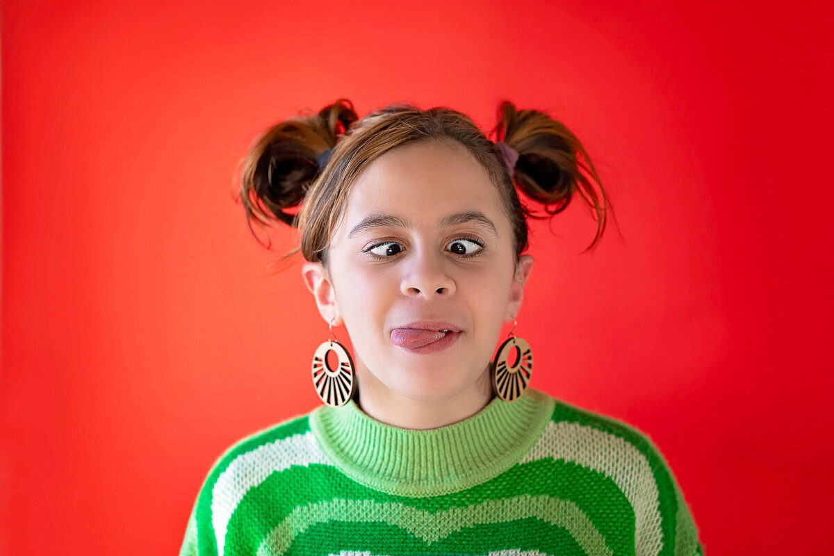 Funny portrait photo session of a young girl doing silly face by Yuliia Terziian Photography