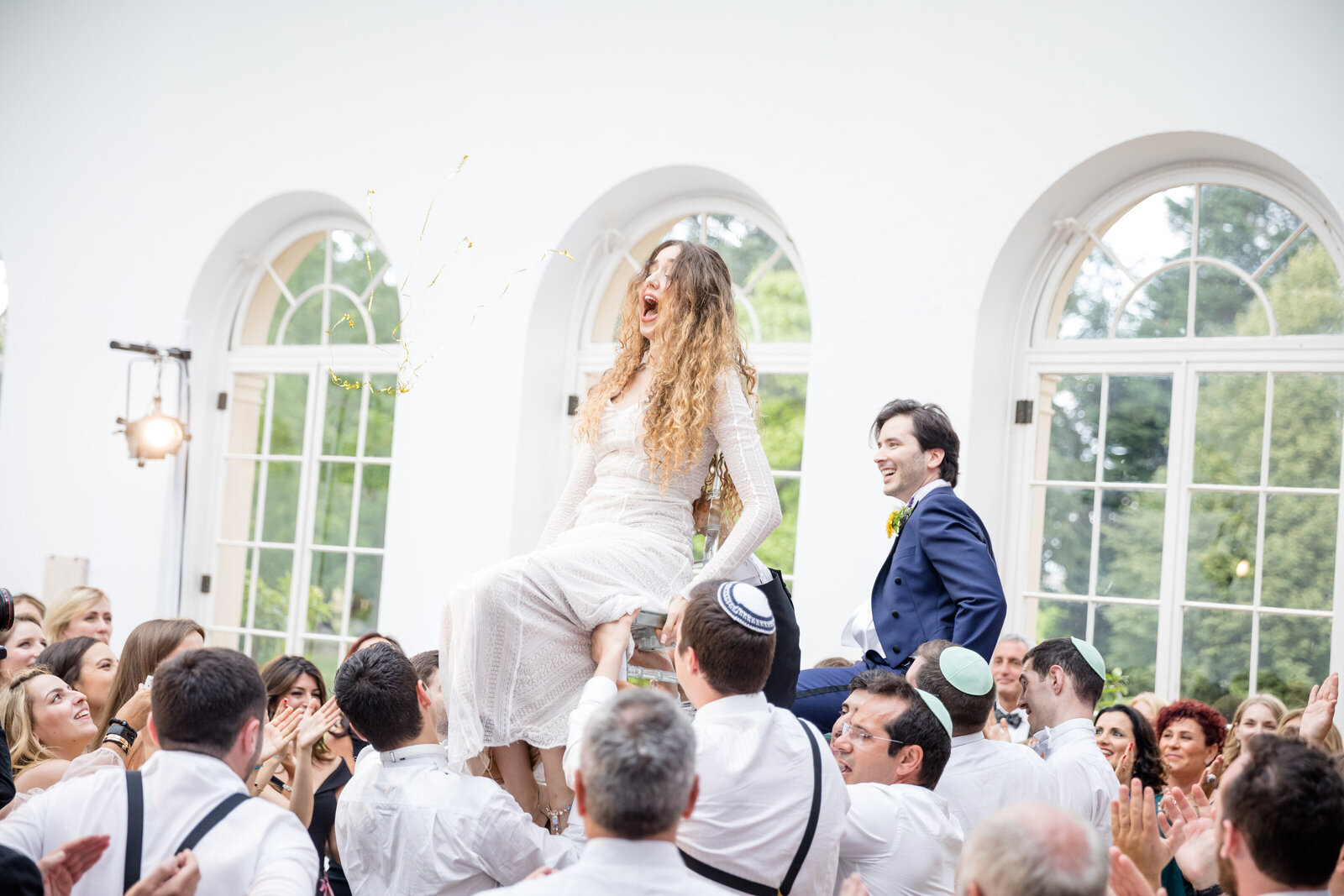 Bride and Groom dancing on chairs at Wrest Park