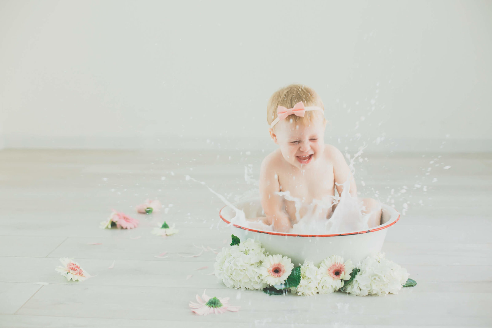 baby splashing milk bath session