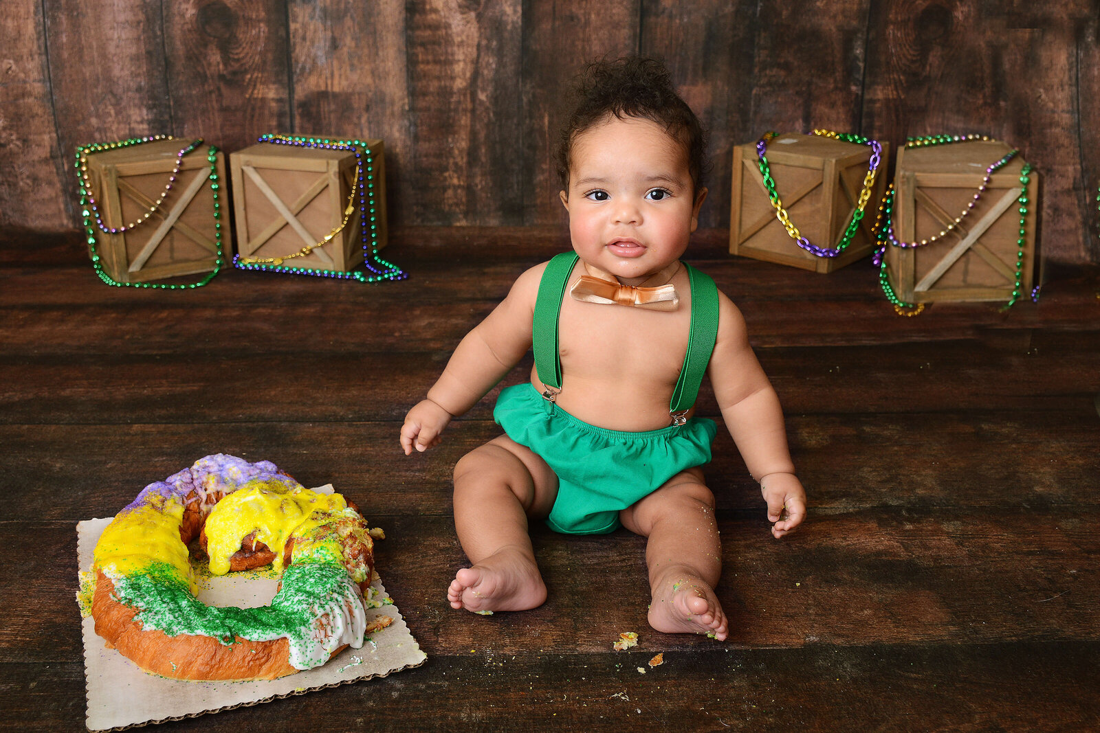 boy smiles at his mardi gras themed photoshoot