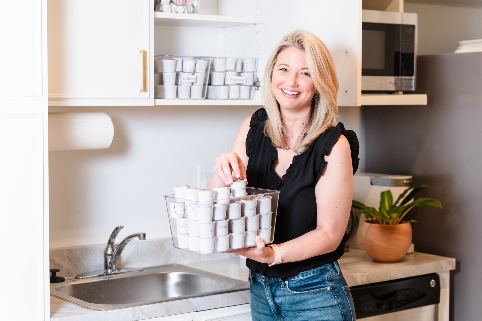 brand photo of a professional organizer holding a container with coffee capsules
