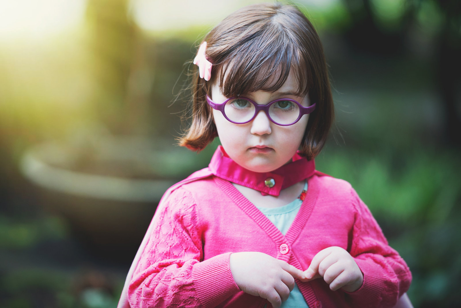 Colorful image of a toddler girl wearing glasses