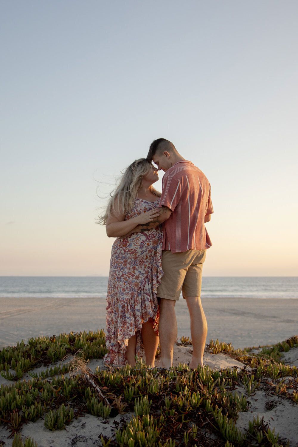 Couple embracing on the beach during sunset