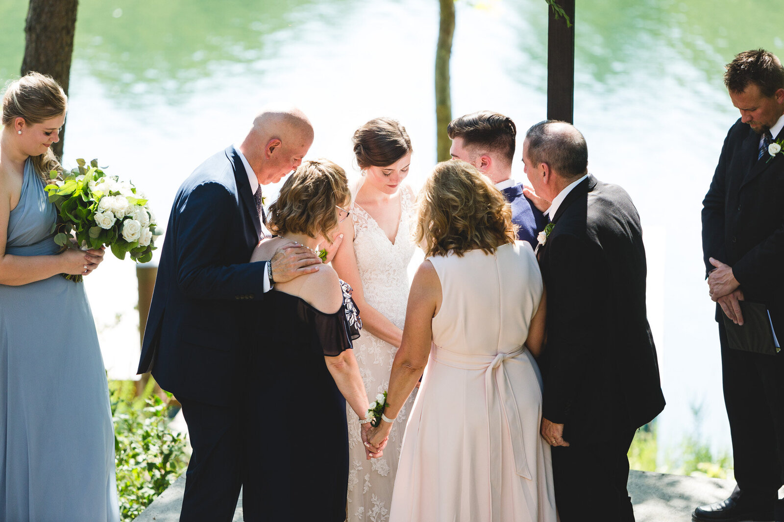 bride and groom being prayed for during ceremony by family micro wedding ohio
