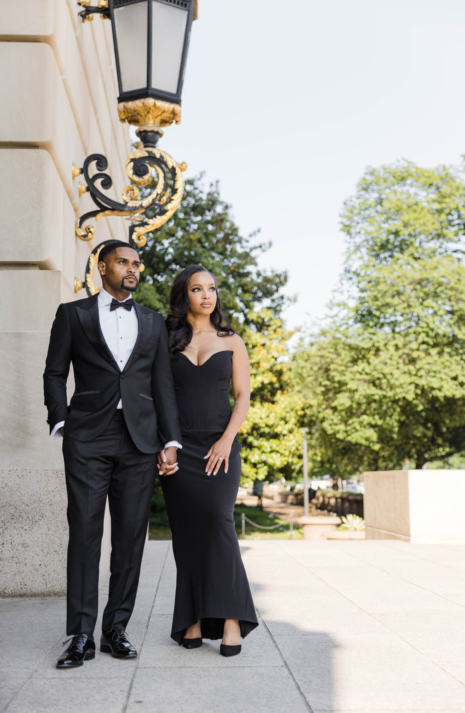 couple in black tie holding hands