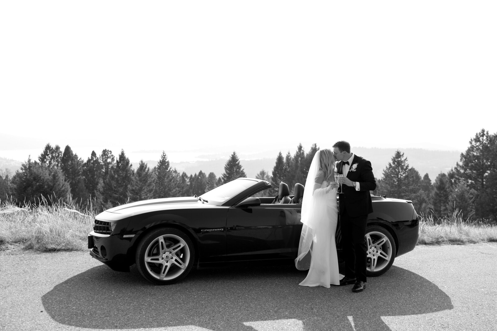 Bride and groom cheering by their getaway vehicle after their Montana wedding