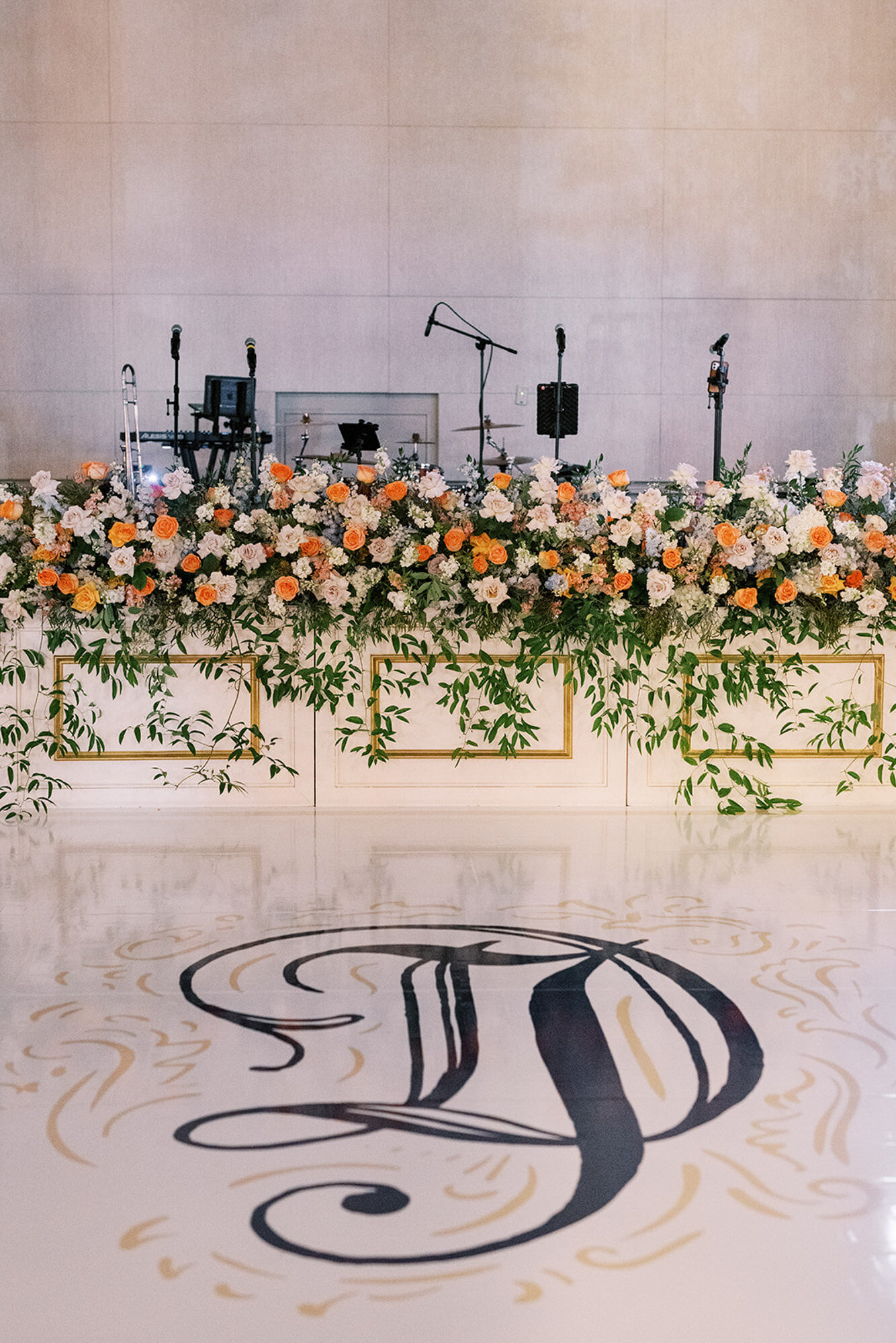 dance floor with wedding monogram and florals
