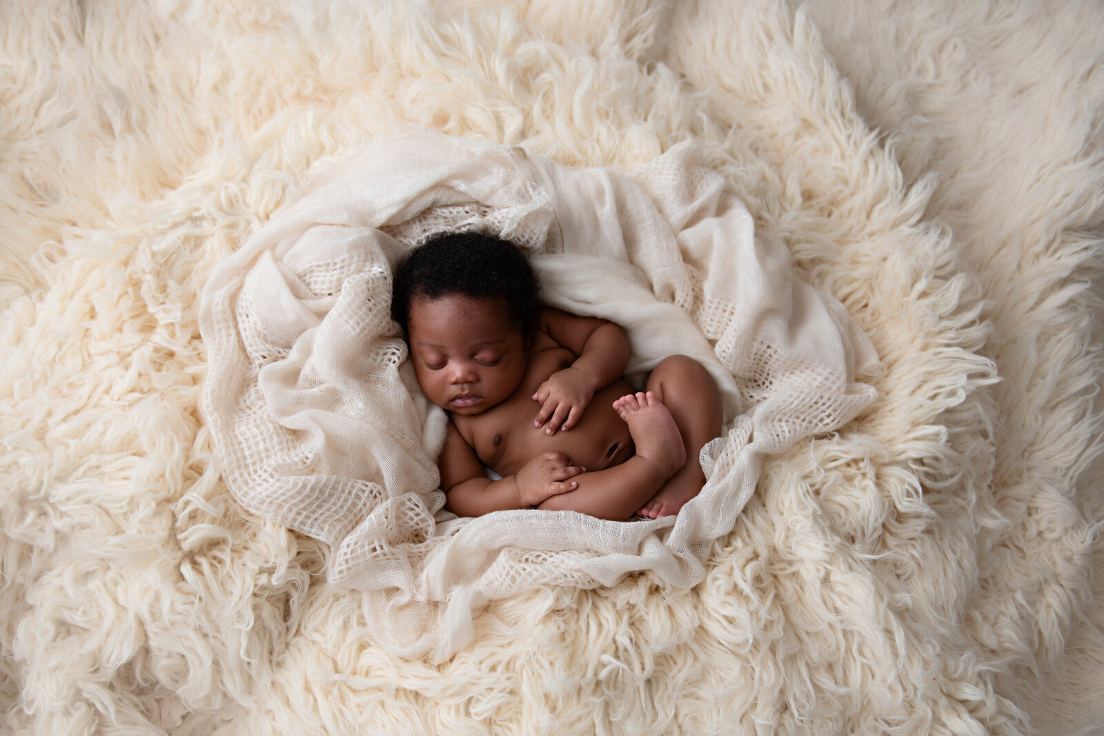 Baby boy laying in cream soft layers at this Detroit Newborn Session with Kat Figlak