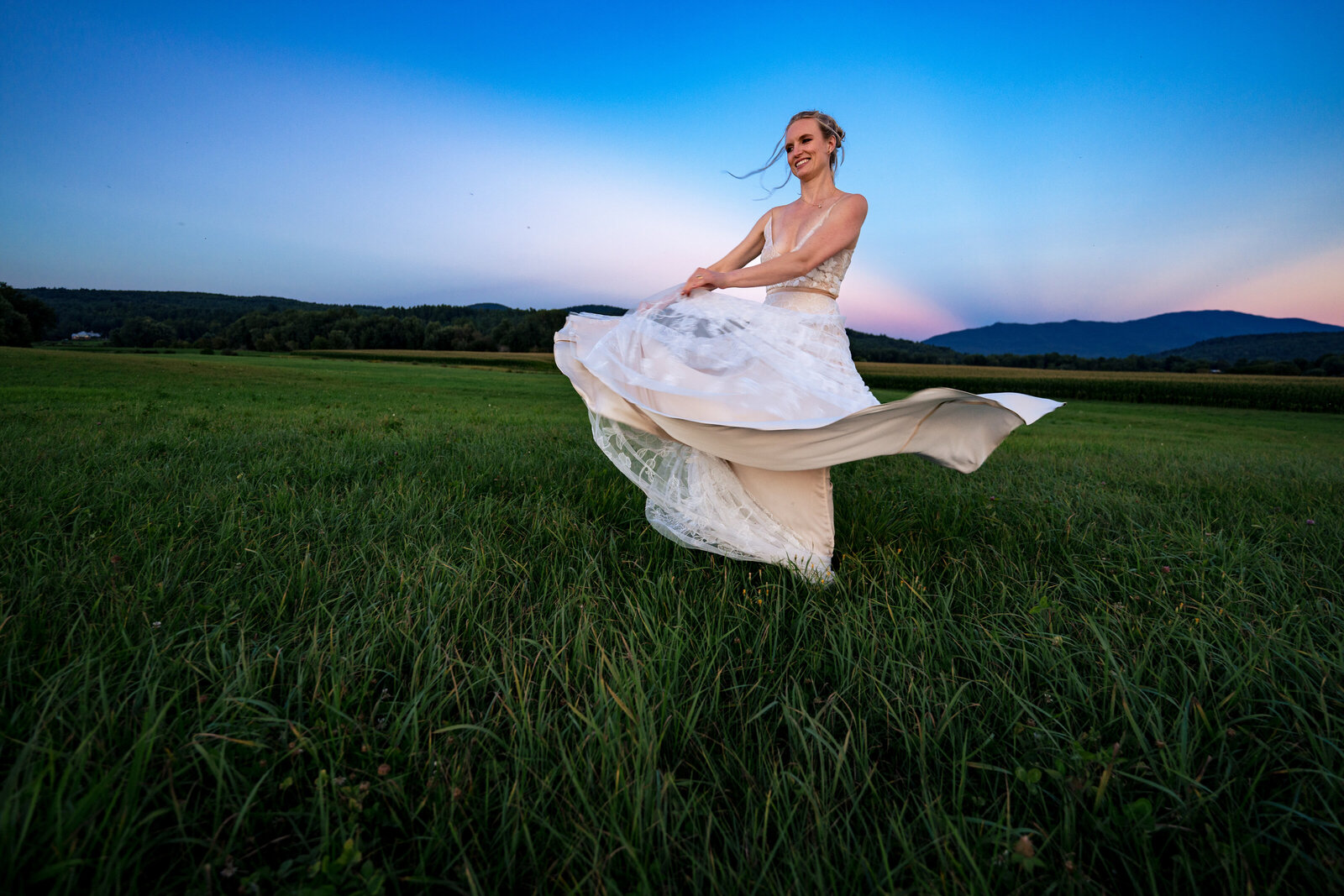 bride-dancing-in-field-at-sunset