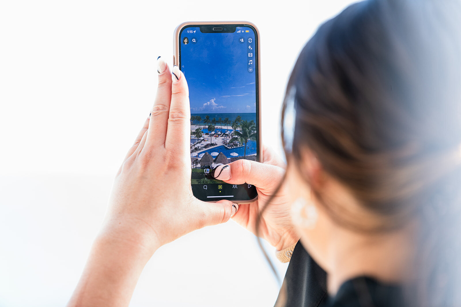 A candid moment of the bride taking a selfie while getting ready for her wedding ceremony, captured in a playful behind-the-scenes shot by CMH Studios.