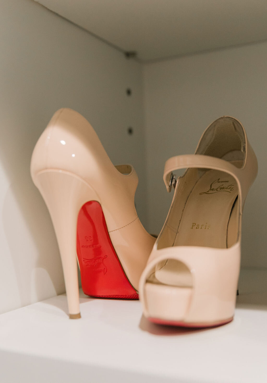 Christian Louboutin red sole shoes organized in closet