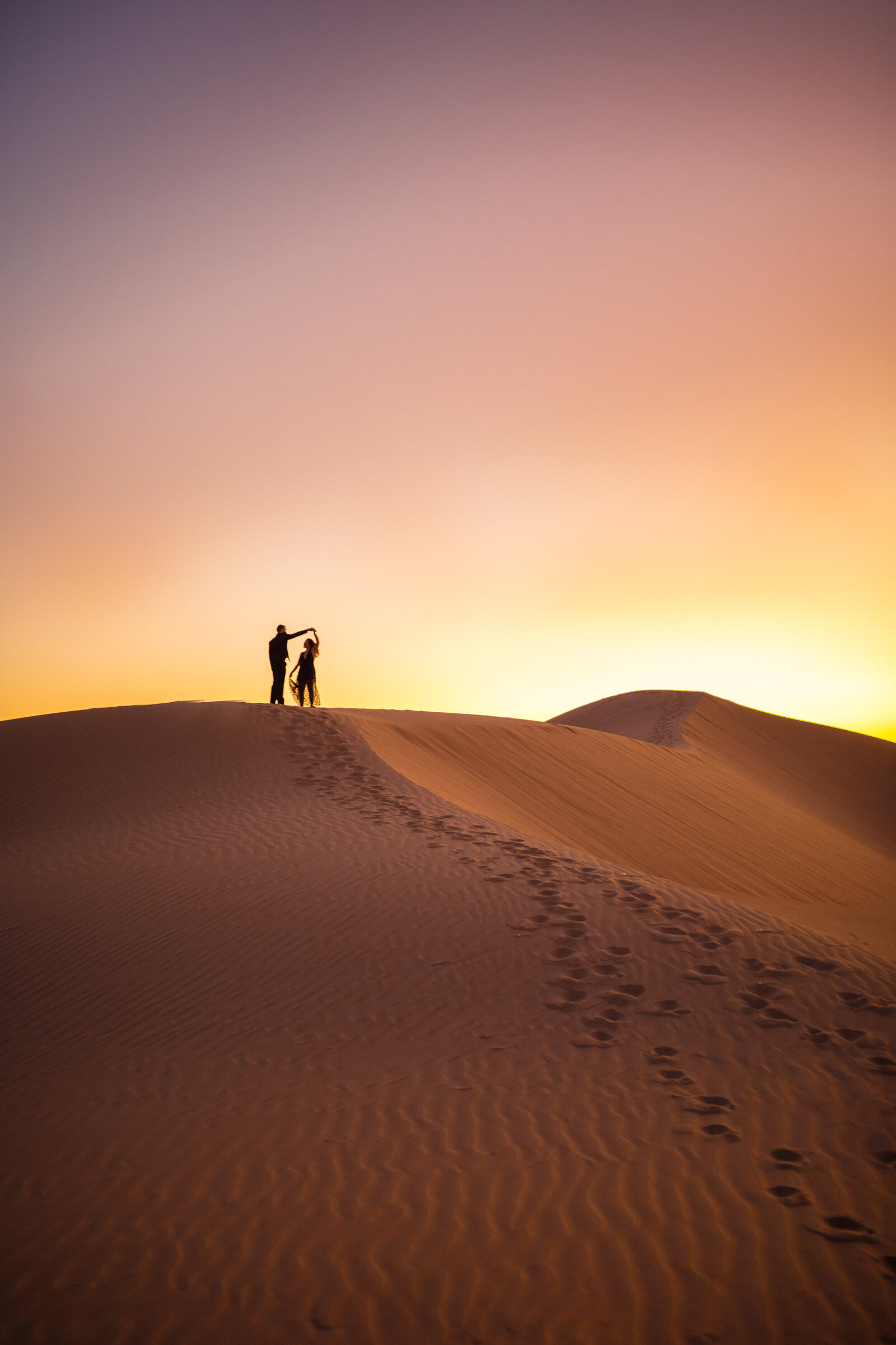 couple dancing on the ridge of the algodones sand dunes