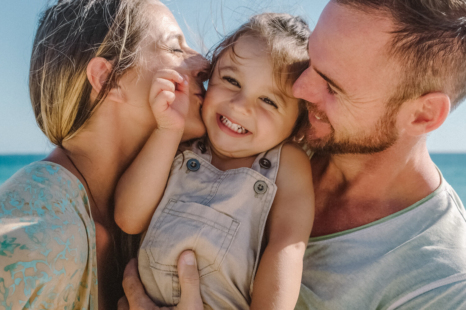 parents kissing son