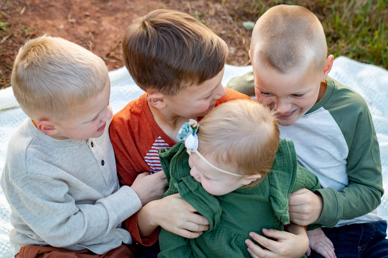 Four siblings tickling each other during a Haymarket family photography session.