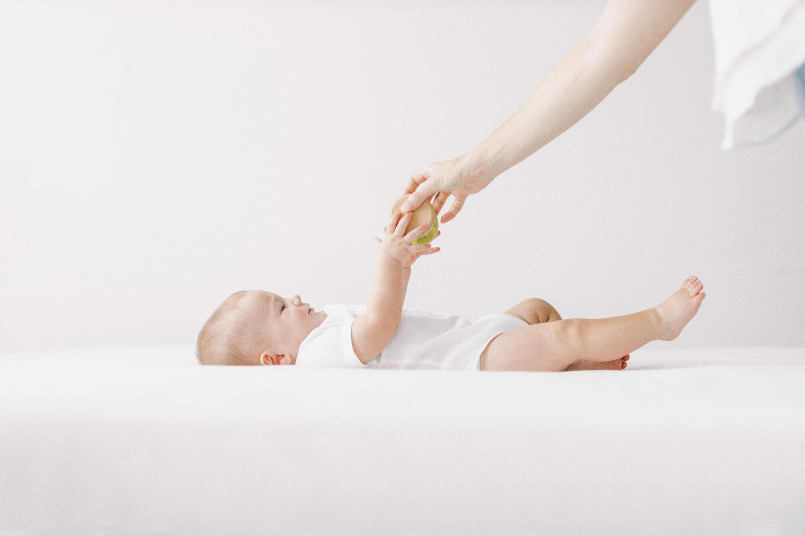 mom-handing-baby-toy