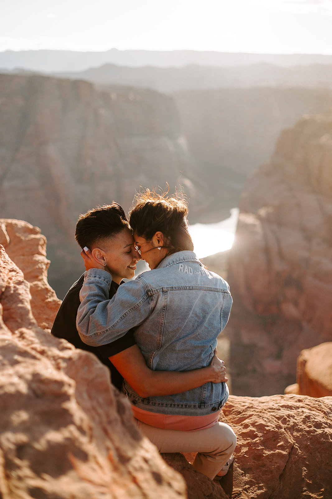 Couple hugging on the edge of the Grand Canyon during their Arizona Engagement session