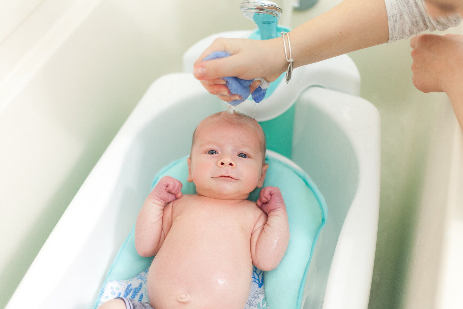 strong-newborn-taking-bath-lifestyle-family-photography