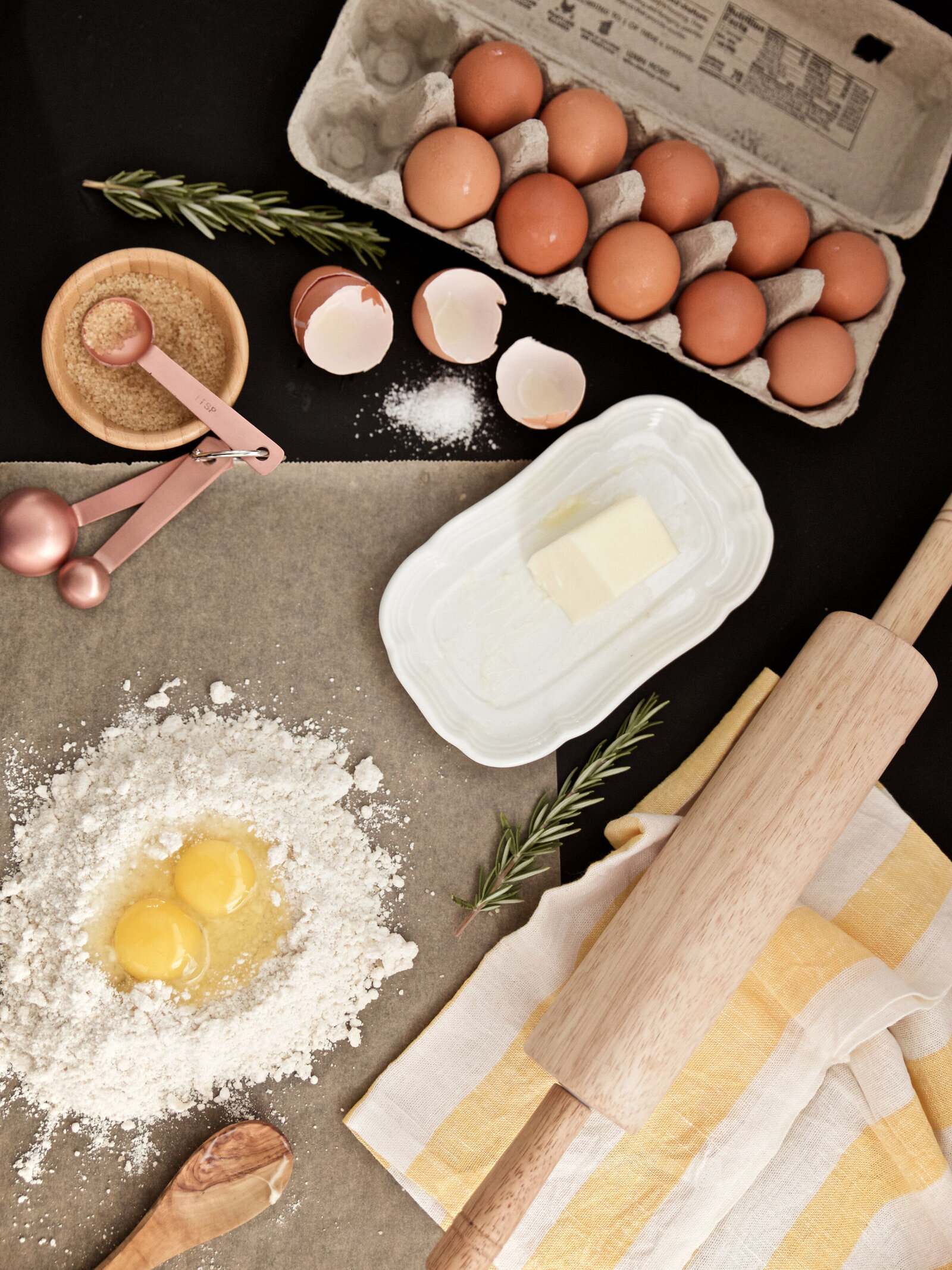 San Diego food photographer and stylist making pasta flat lay with eggs, flour, rolling pin