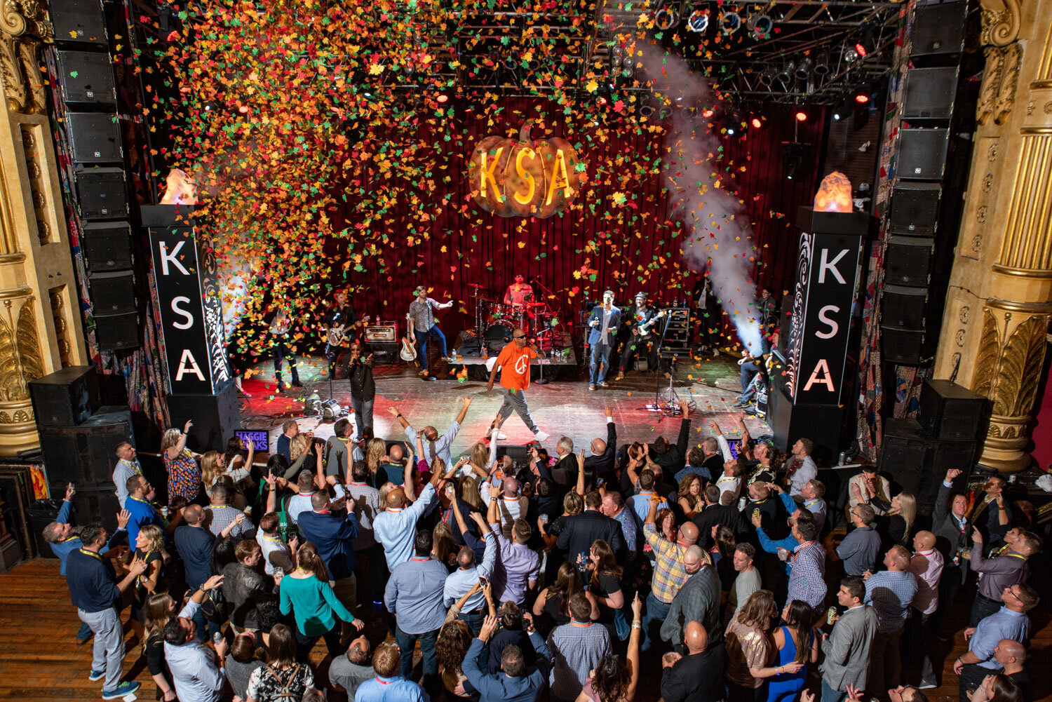 Performer on stage as colorful confetti rains over the crowd
