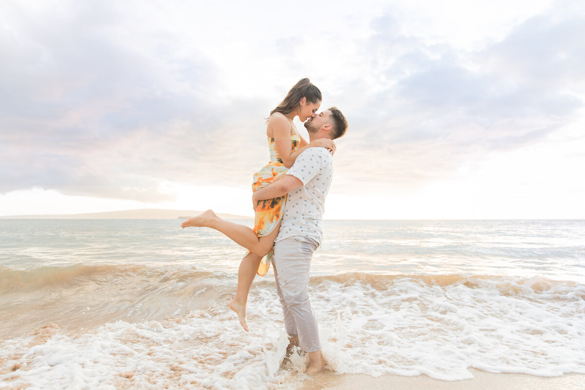 Maui Proposal Packages on the Beach  of Man lifting up fiancé