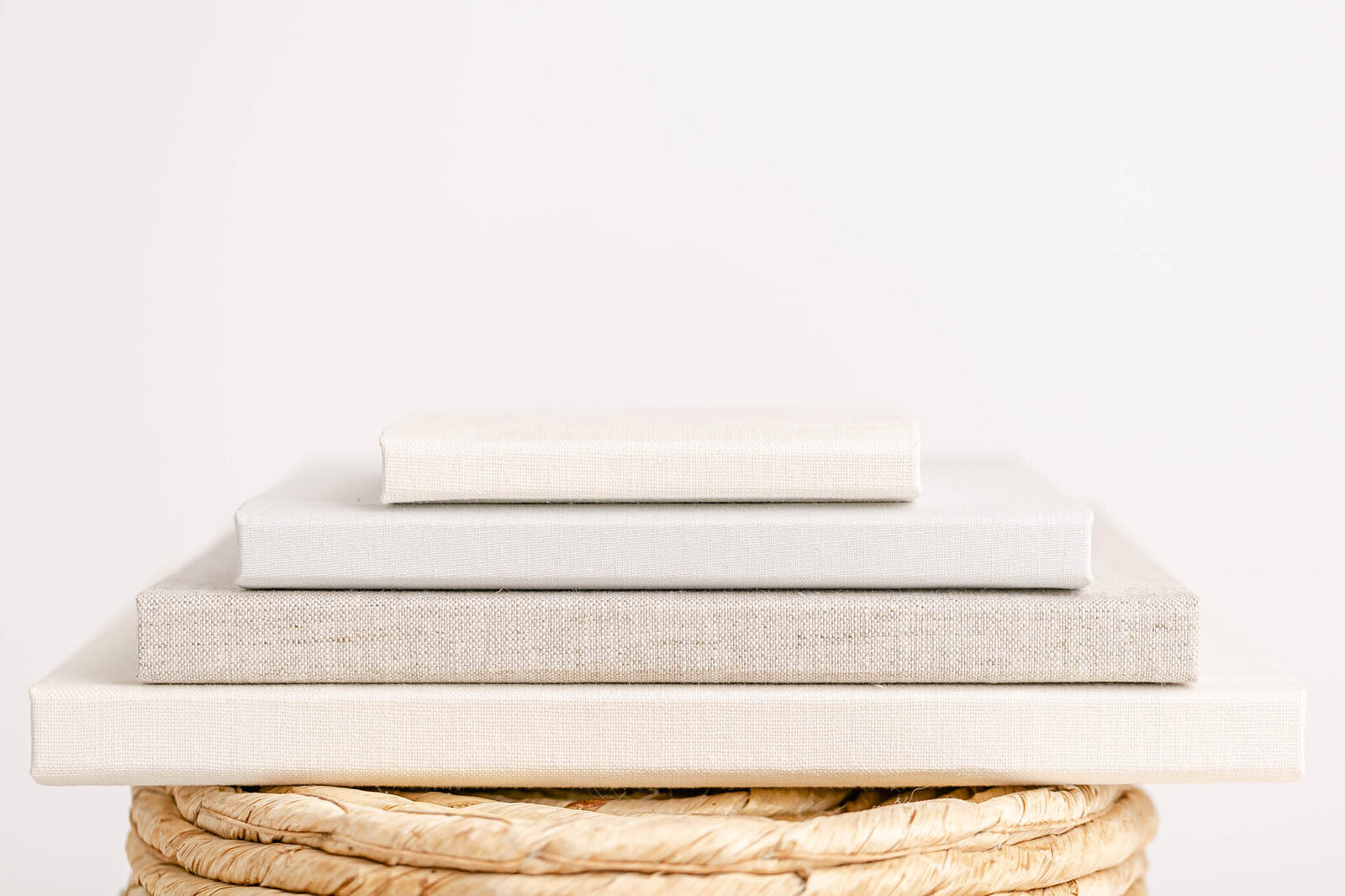 Stack of beautiful linen heirloom photo albums stacked on top of each other.