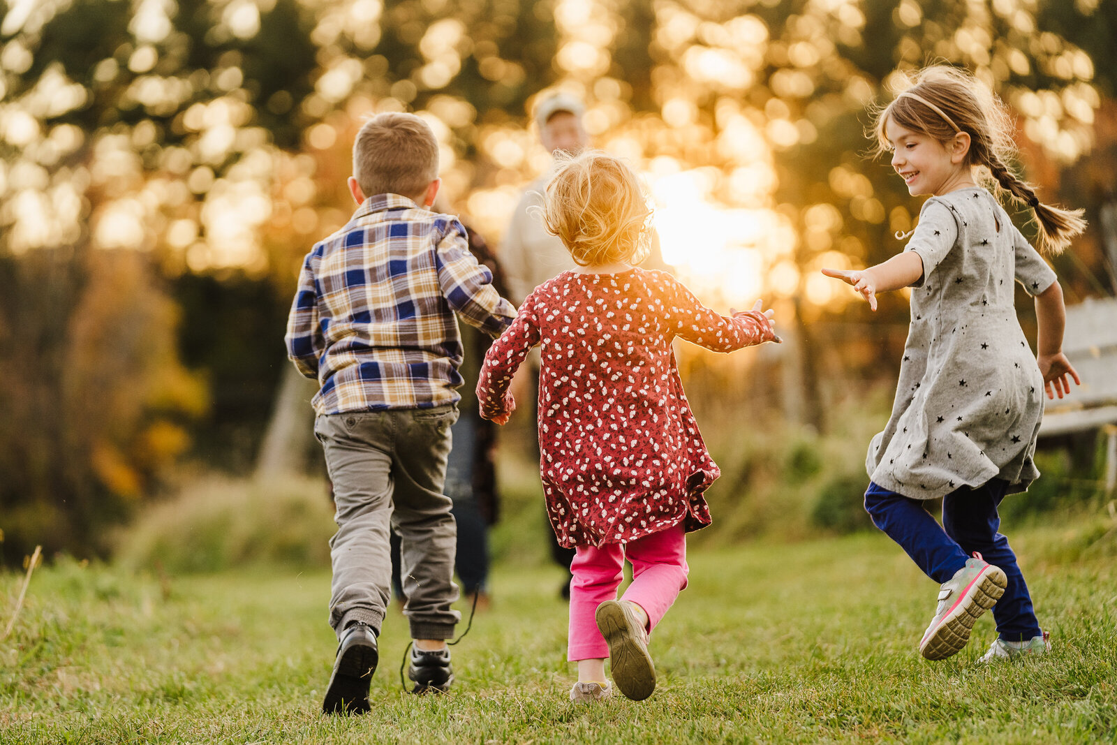 three kids run holding hands