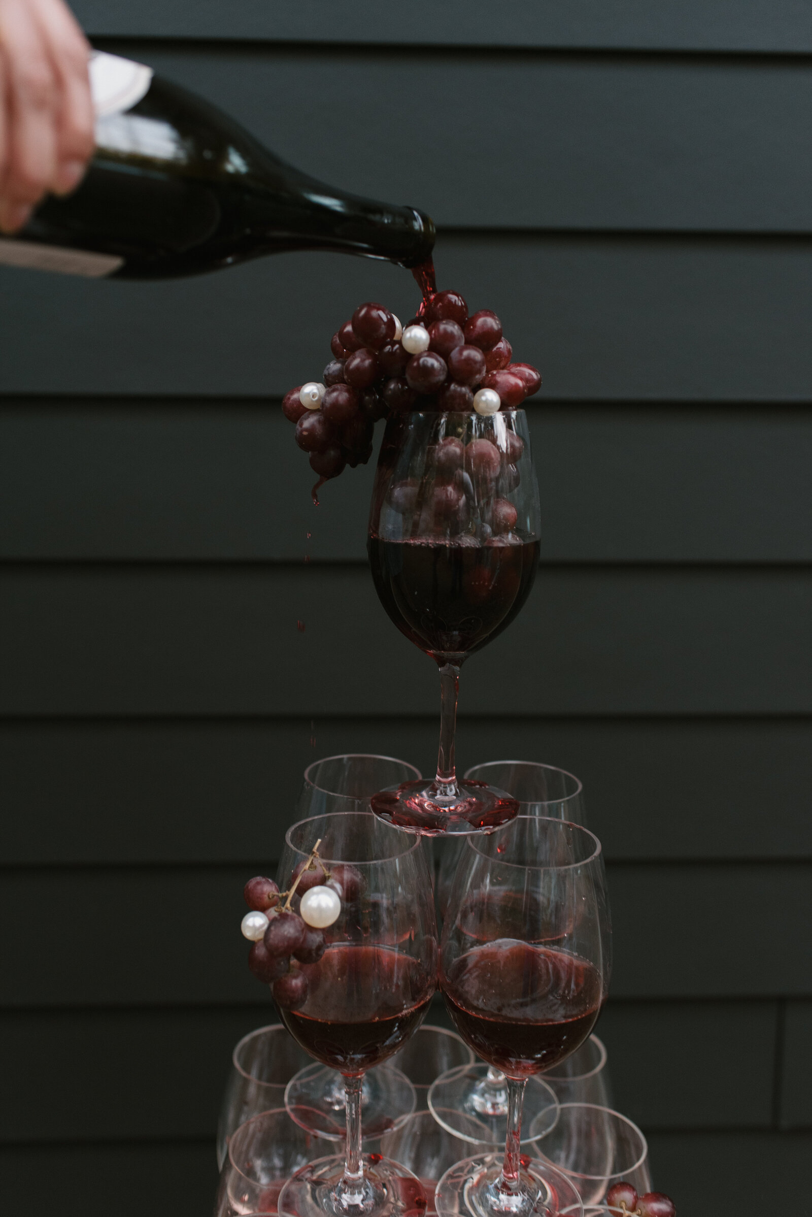 red wine glass tower with grapes and pearls