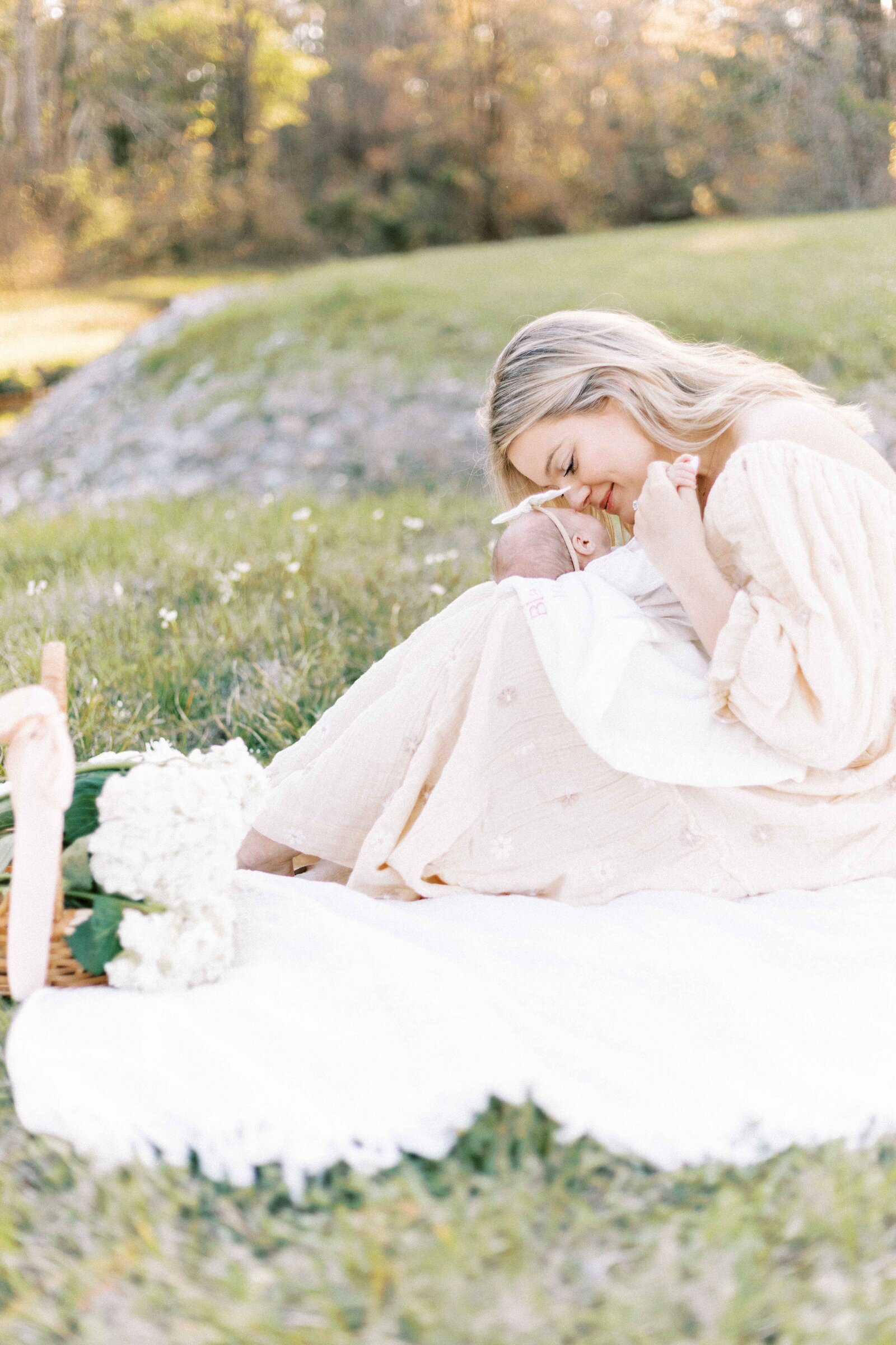 mom kissing baby outside in peoria illinois newborn photos 