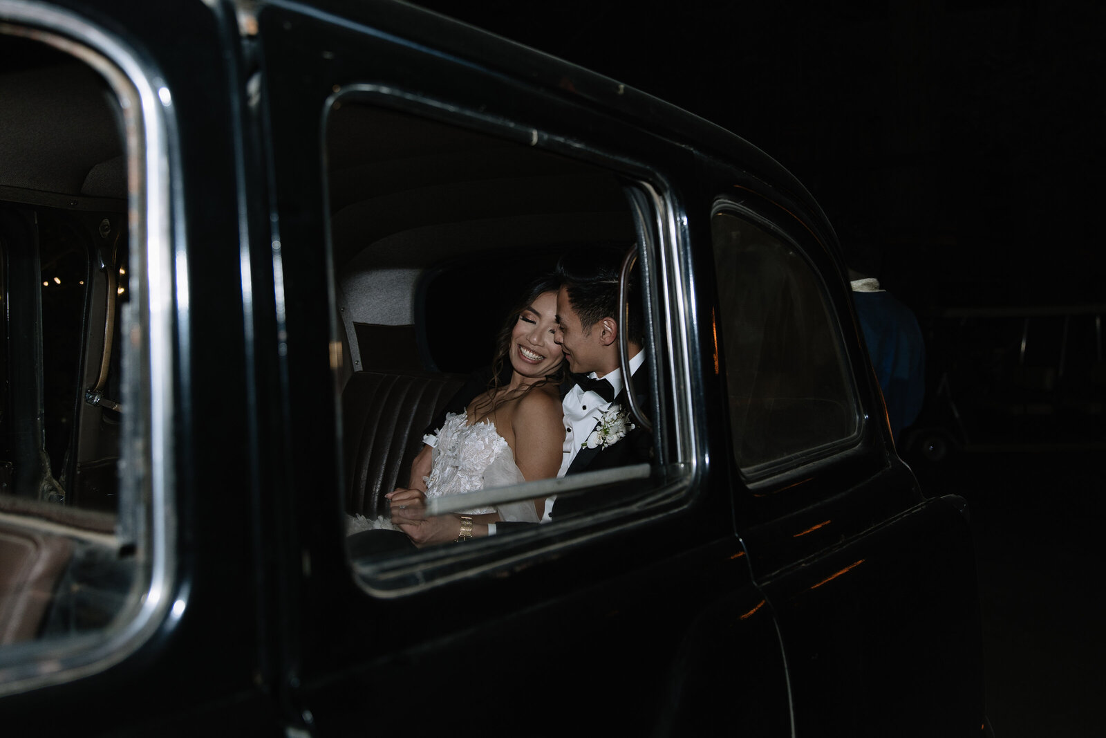 Couple embrace in classic car by Washington adventure elopement photographer