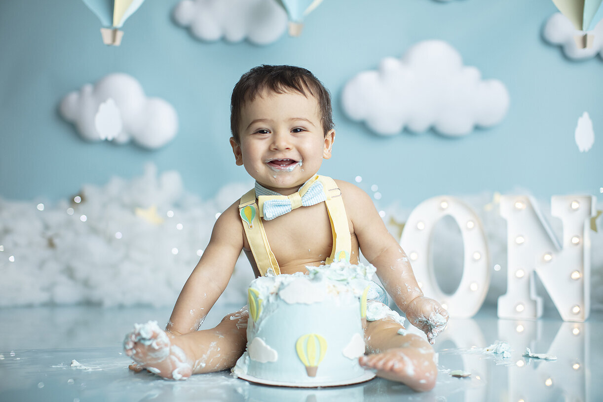 Happy baby at his Up Up and Away cake smash.