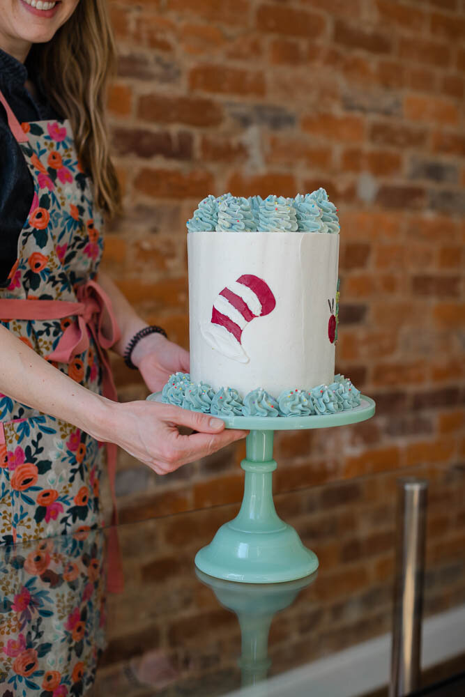 Color image of baker holding her cake